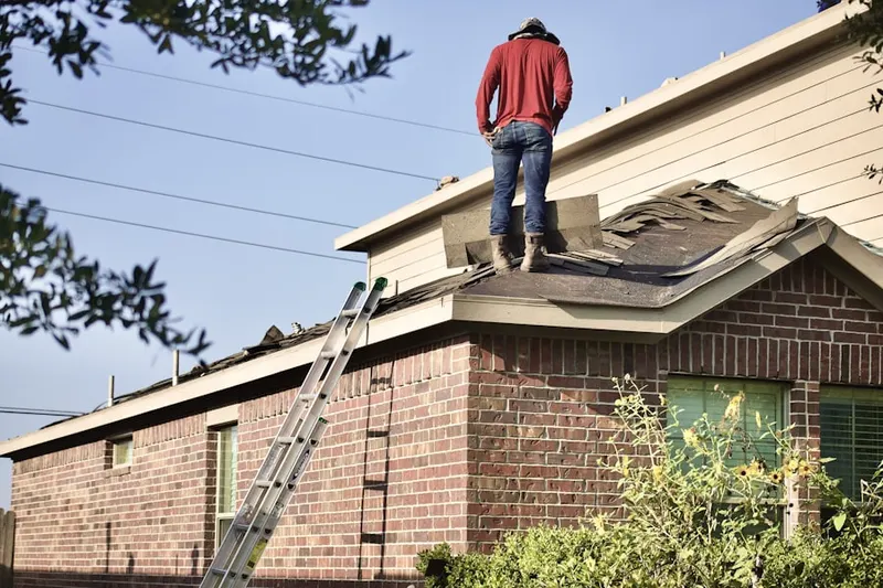 Professional roofer working on a residential roof in Twin Eagle Farms